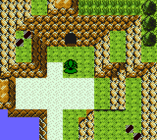 A screenshot from Pokémon Prism showing an unreleased area. It is a small, grassy gully on the coast surrounded by steep cliffs. The player is standing in the centre and facing upwards towards a cave entrance.